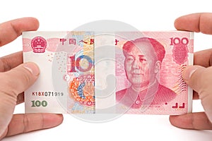 Hand holding stacks of 100 RMB paper currency with clipping path