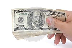 Hand holding stacks of 100 USD paper currency with clipping path