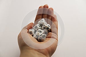 Hand holding the standart set of rpg desktop white dice