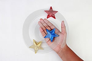 Hand holding a star with different colors