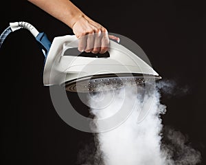 Hand holding steam generator iron