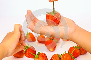 Hand holding strawberry