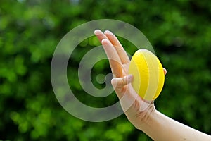 Hand holding stress ball and squeezing by thumb and little finger for strengthen the muscles of finger hand and wrist