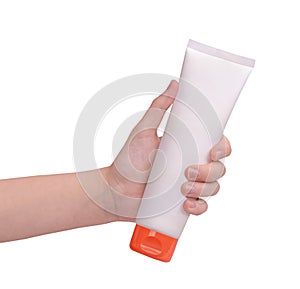 A hand holding sunscreen cream isolated on white background