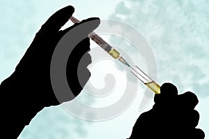 Hand holding a syringe with a covid-19 test vaccine