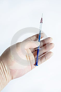 The hand holding the syringe.Isolated on a white background