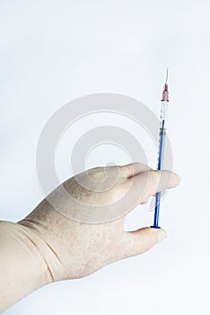 The hand holding the syringe.Isolated on a white background