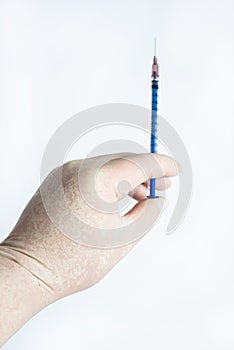 The hand holding the syringe.Isolated on a white background