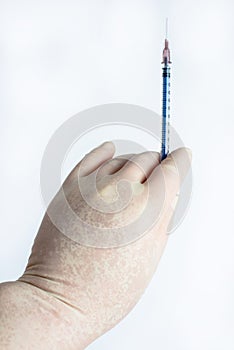 The hand holding the syringe.Isolated on a white background