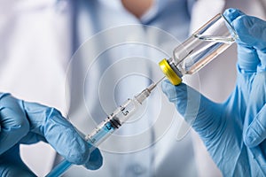 Hand holding syringe and vaccine photo