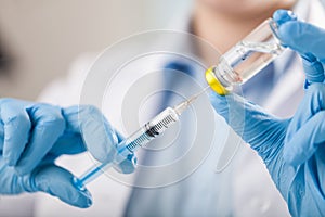 Hand holding syringe and vaccine photo