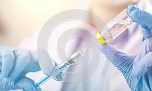 Hand holding syringe and vaccine photo