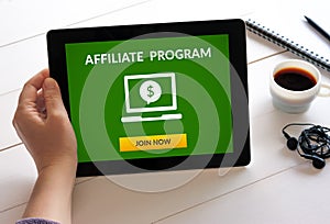 Hand holding tablet with affiliate program concept on screen