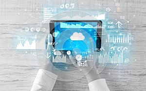 Hand holding tablet and checking finantial report concept