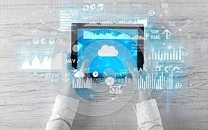 Hand holding tablet and checking finantial report concept