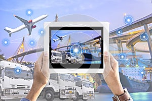 Hand holding tablet with screen interface in front Logistics Industrial