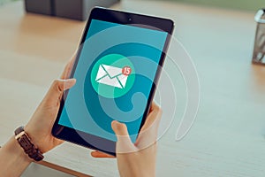 Hand holding tablet and show email screen on application mobile.