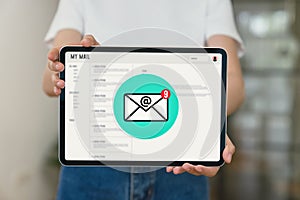 Hand holding tablet and show email screen on application mobile in the office.