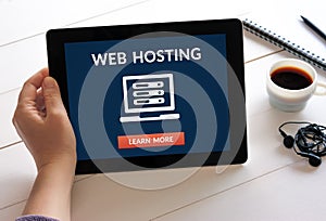 Hand holding tablet with web hosting concept on screen