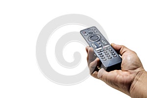Hand holding television and audio remote control on white background