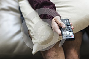 Hand holding television remote control