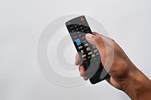 Hand holding television remote control