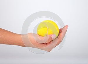 Hand holding tennis ball