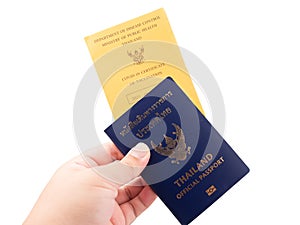 Hand holding Thailand official passport and vaccine passport are on isolated white background