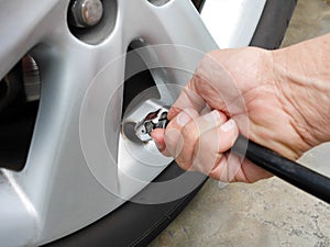 Hand holding tire inflator