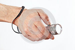 Hand holding a torchlight on white background