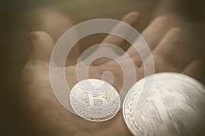 Hand holding transparent bitcoin. Tonned double exposure.