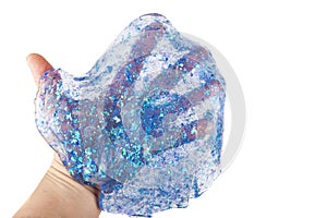 Hand holding a transparent blue glitter slime isolated on white