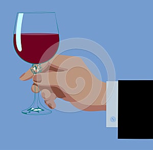 Hand holding transparent glass with pouring red wine isolated on blue