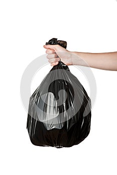 Hand holding trash bag