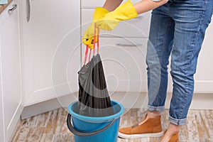 Hand holding a trash garbage bag at home to take it away