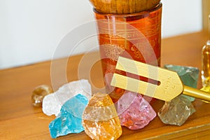 Hand holding a tuning fork and crystal stone  .