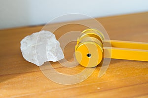 Hand holding a tuning fork and crystal stone  .