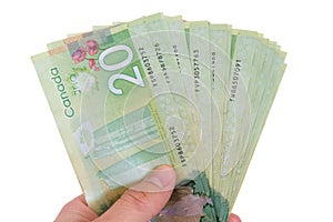 Hand holding twenty canadian dollar bills