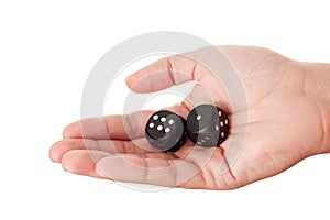 Hand holding two black dices