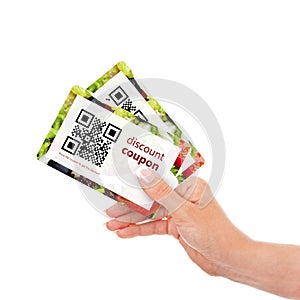 Hand holding two discount coupons with qr code isolated over wh
