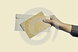 Hand holding two envelopes