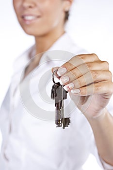 Hand holding two house keys on a key chain