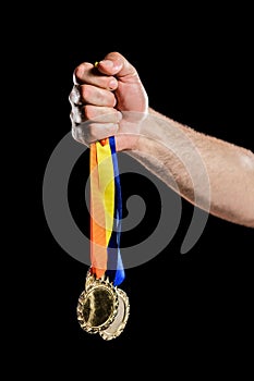 Hand holding two olympic gold medal