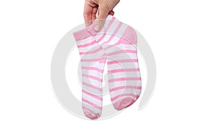 A hand holding two, pair pink and white striped cotton organic socks isolated on white