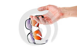 Hand holding two sunglasses. Men`s and women`s sunglasses. Close