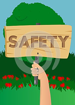 Hand holding up a banner with Safety text.