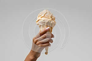 A Hand Holding Up An Ice Cream Cone In The Air