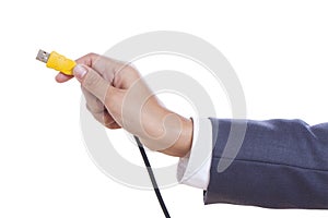 hand holding USB cable.