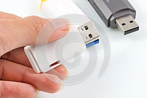 Hand holding usb flash, usb memory stick on white