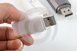 Hand holding usb flash, usb memory stick on white